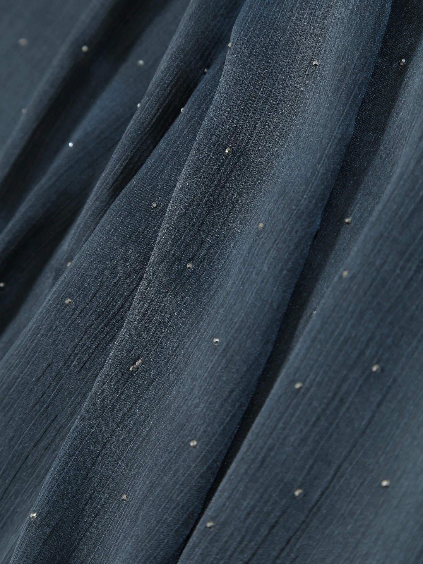 Close-up of textured fabric with small diamante details on a Premium Diamante Silk Hijab - Vintage Indigo.