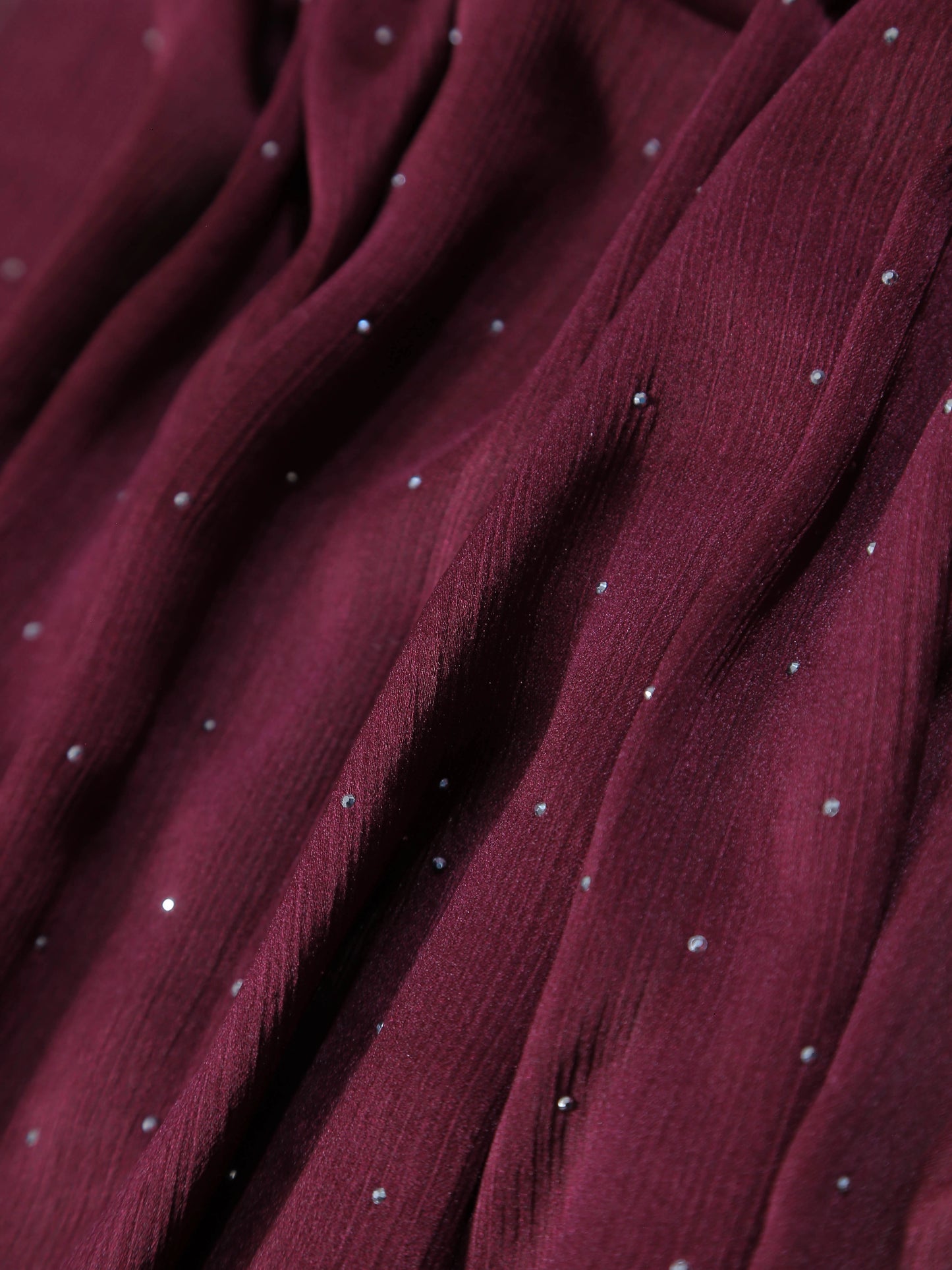 Close-up of Premium Diamante Silk Hijab - Maroon fabric with delicate shimmering diamante details and soft texture.