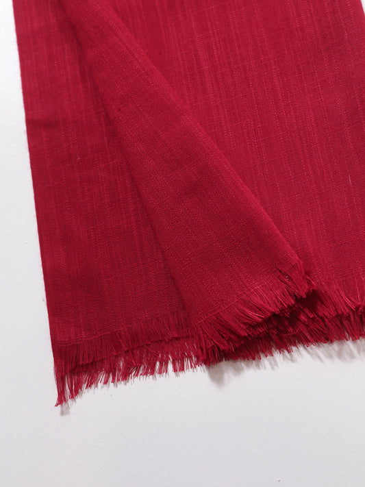 Red fabric with frayed edges on a white background