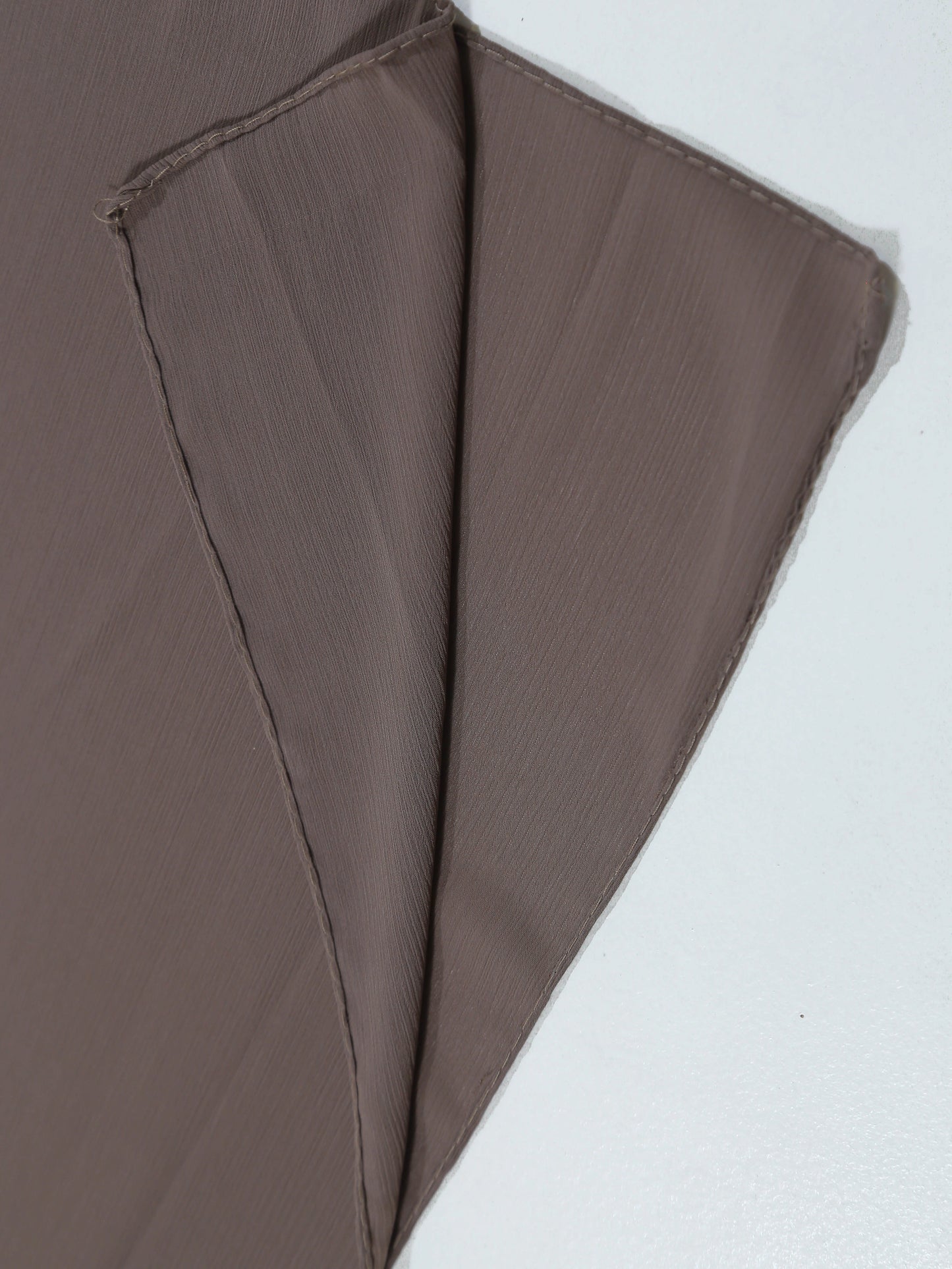Brown fabric folded on a white background