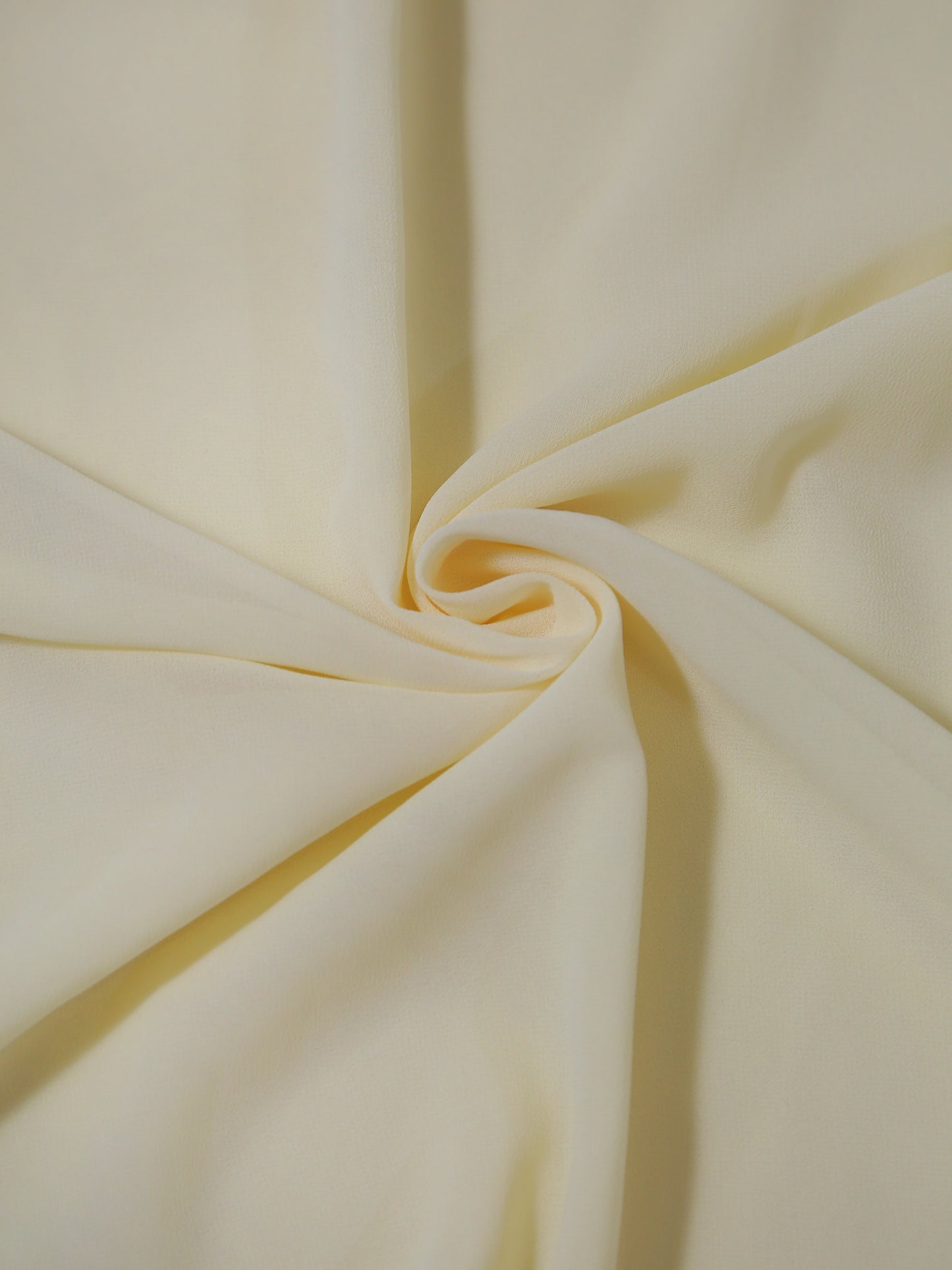 Close-up of light yellow fabric with folds
