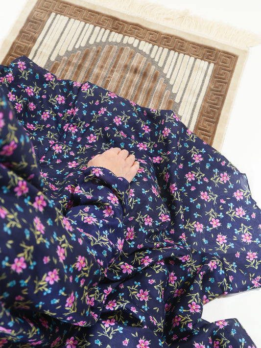 Navy blue fabric with pink floral pattern on a wooden surface