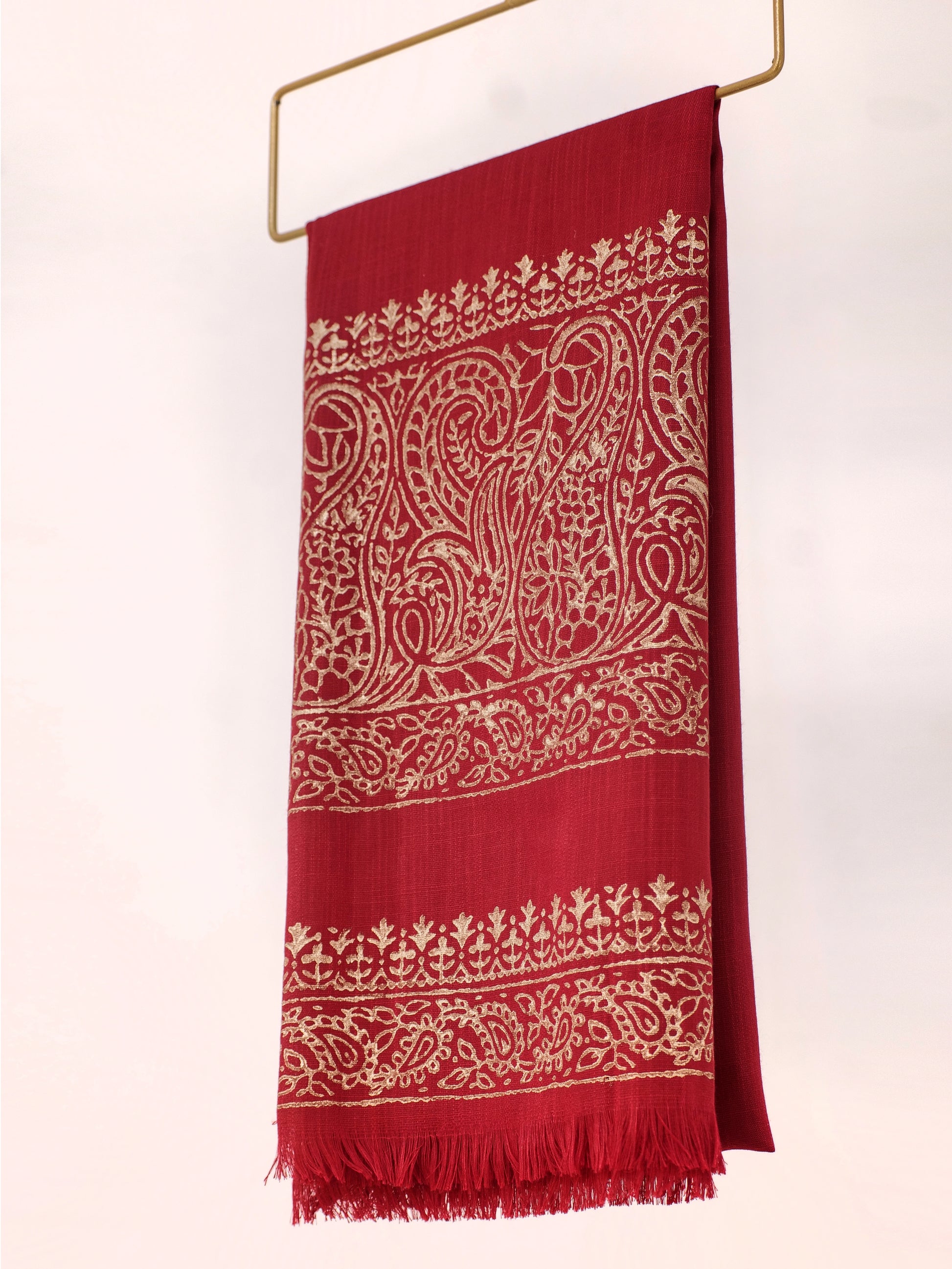 Red scarf with white intricate patterns on a white background