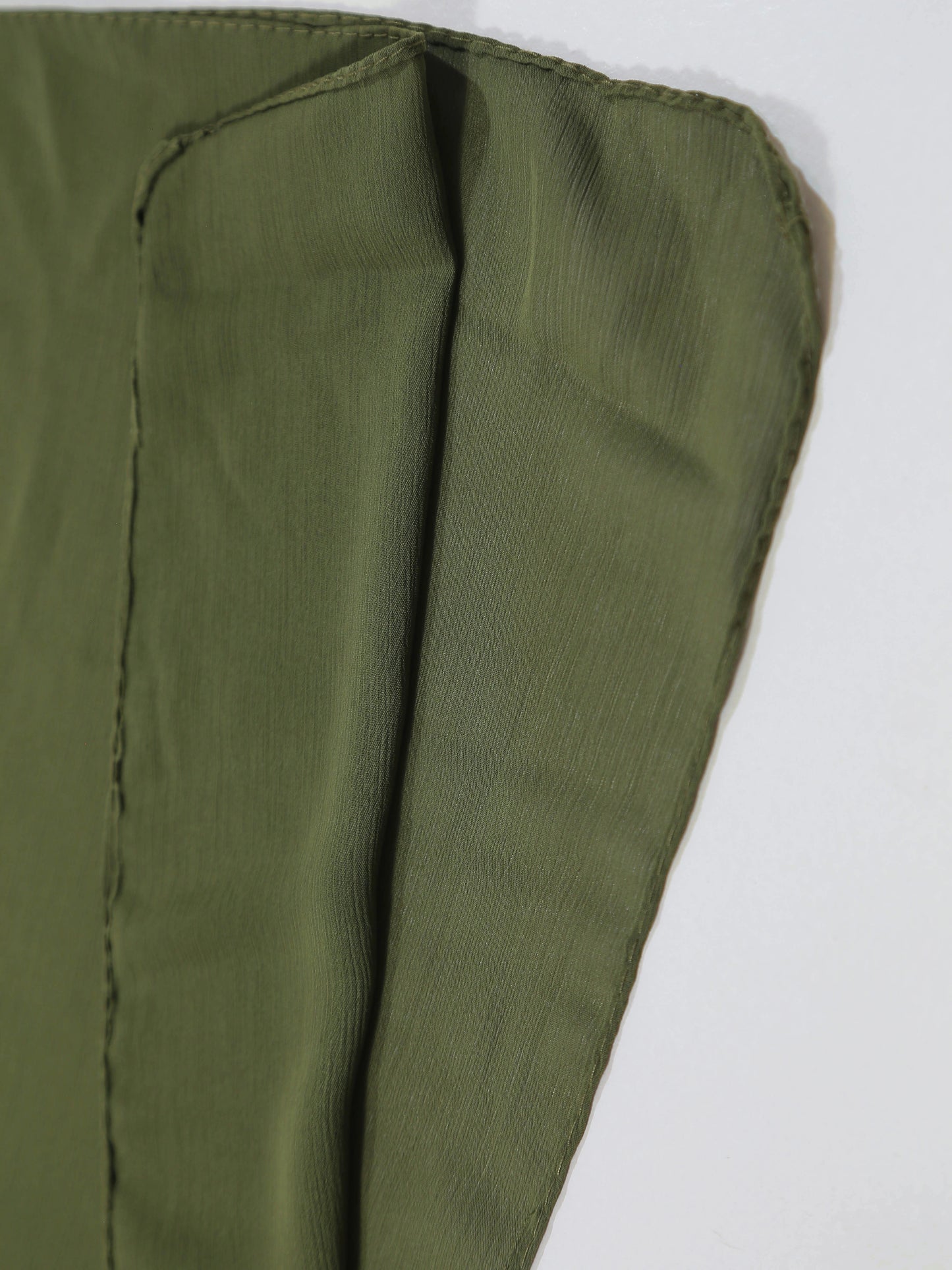 Close-up of green fabric with a white background