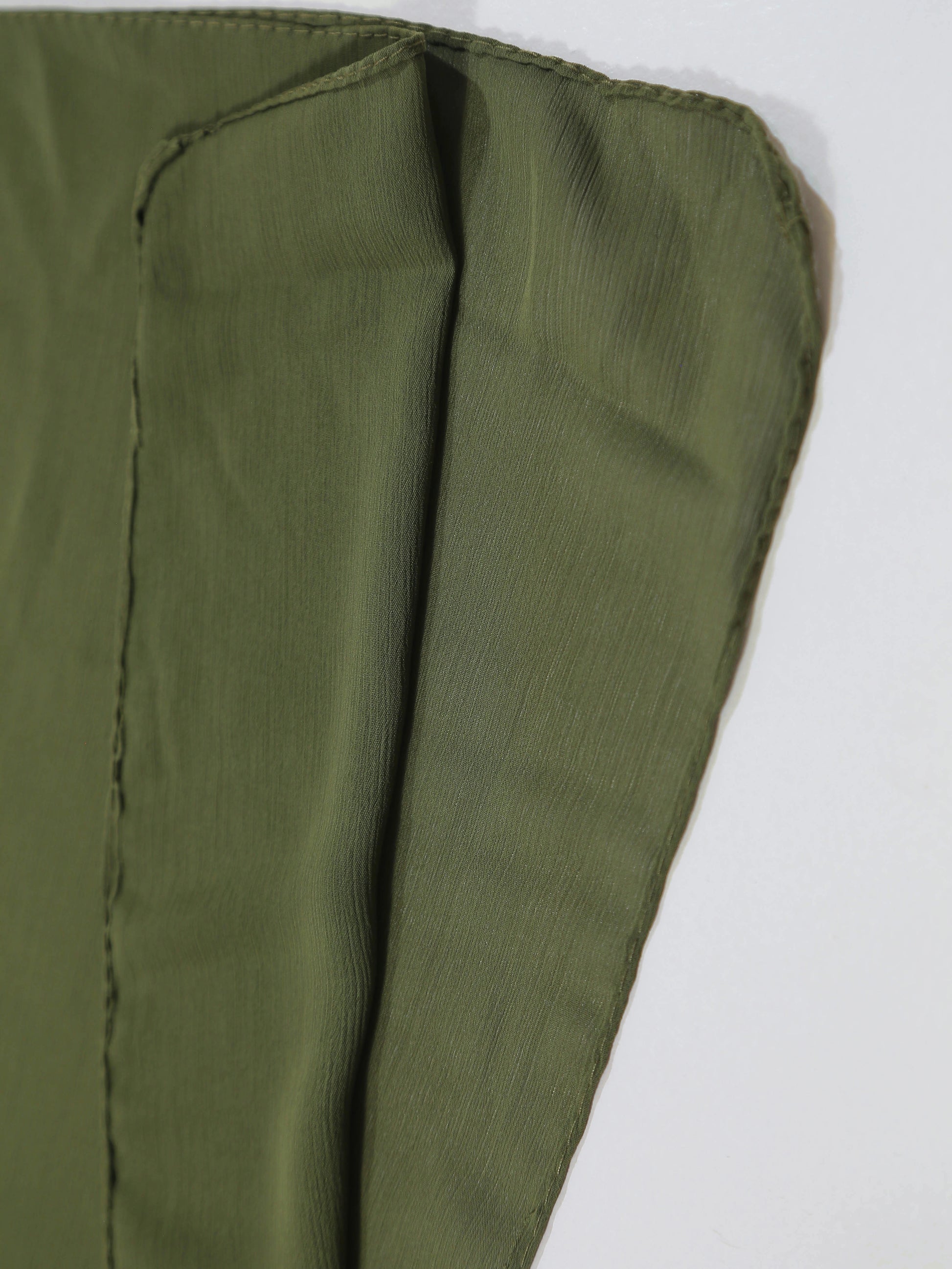 Close-up of green fabric with a white background