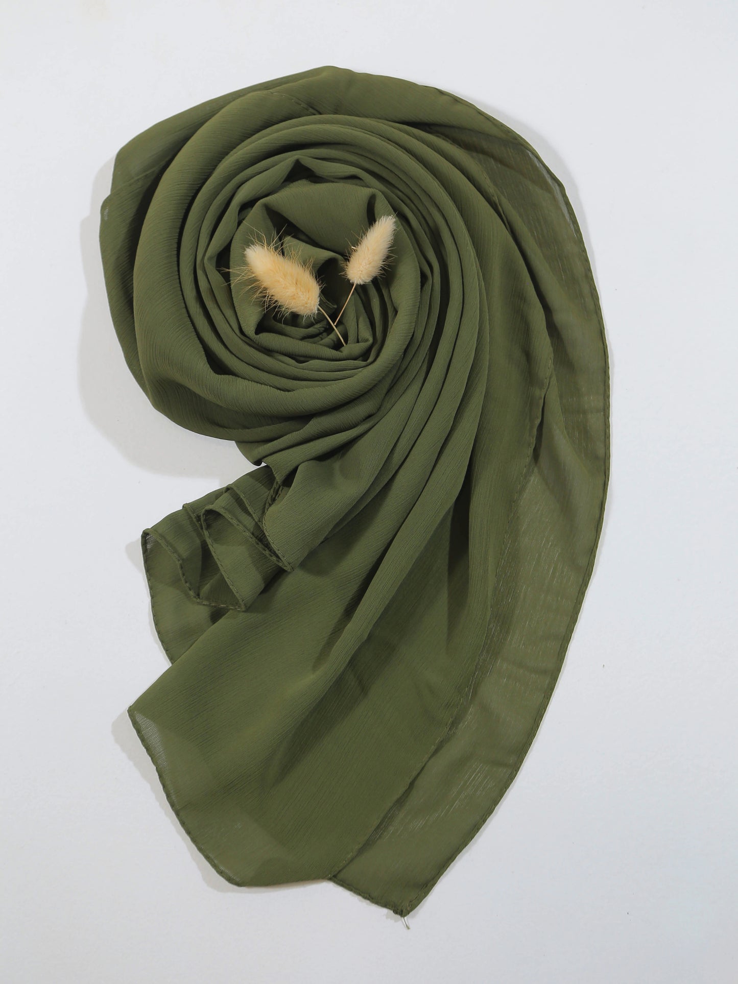 crinkle georgette Green scarf with a small plant on a white background