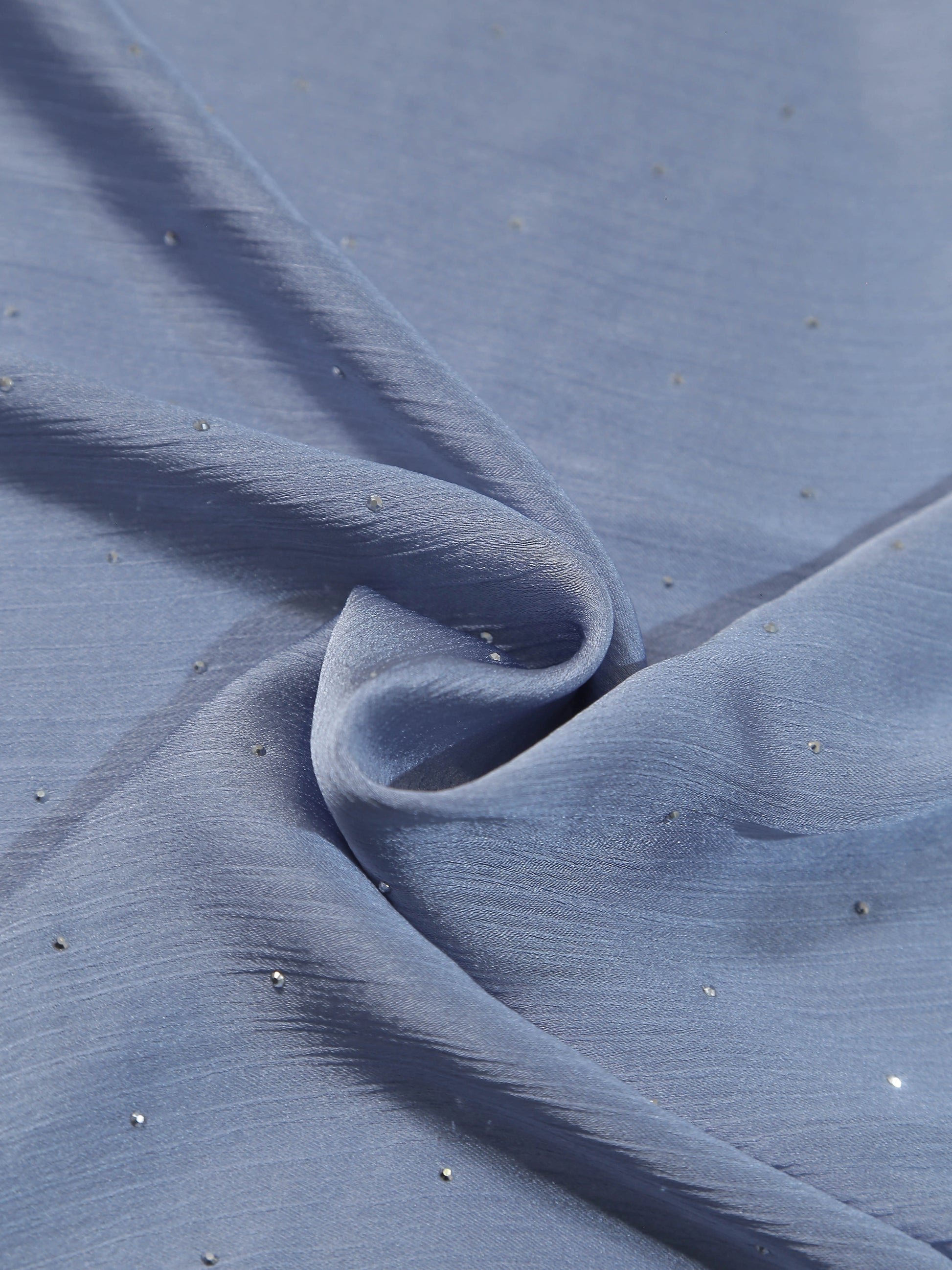 Close-up of folded Premium Diamante Silk Hijab - Arctic Blue fabric with delicate shimmering diamanté accents.