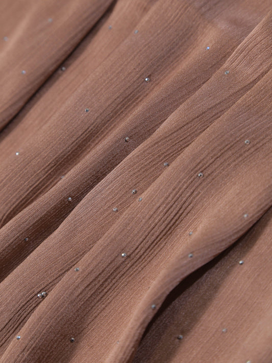 Close-up of textured fabric with small sparkling details on the Premium Diamante Silk Hijab - Brown.