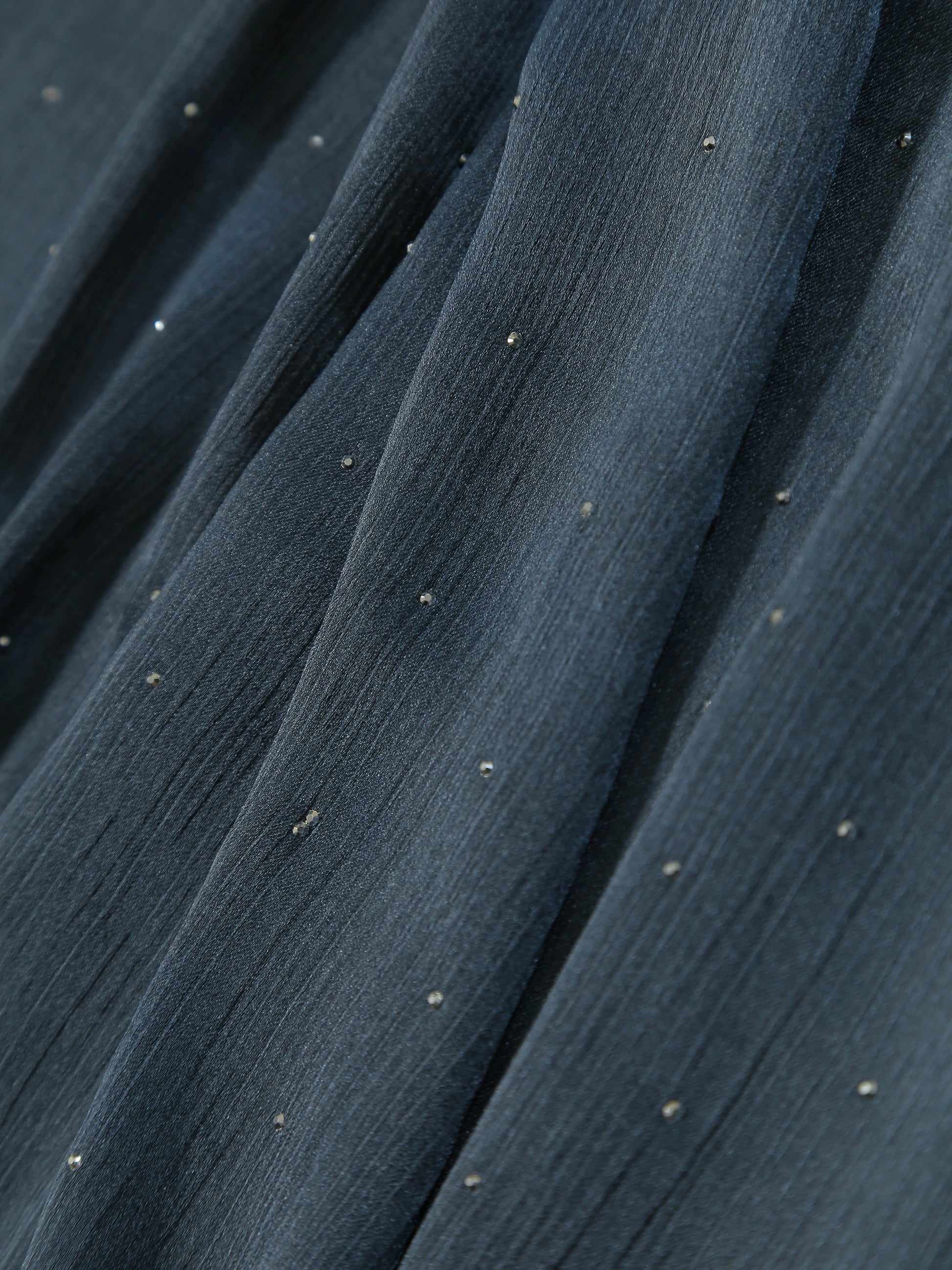 Close-up of textured fabric with small diamante details on a Premium Diamante Silk Hijab - Vintage Indigo.