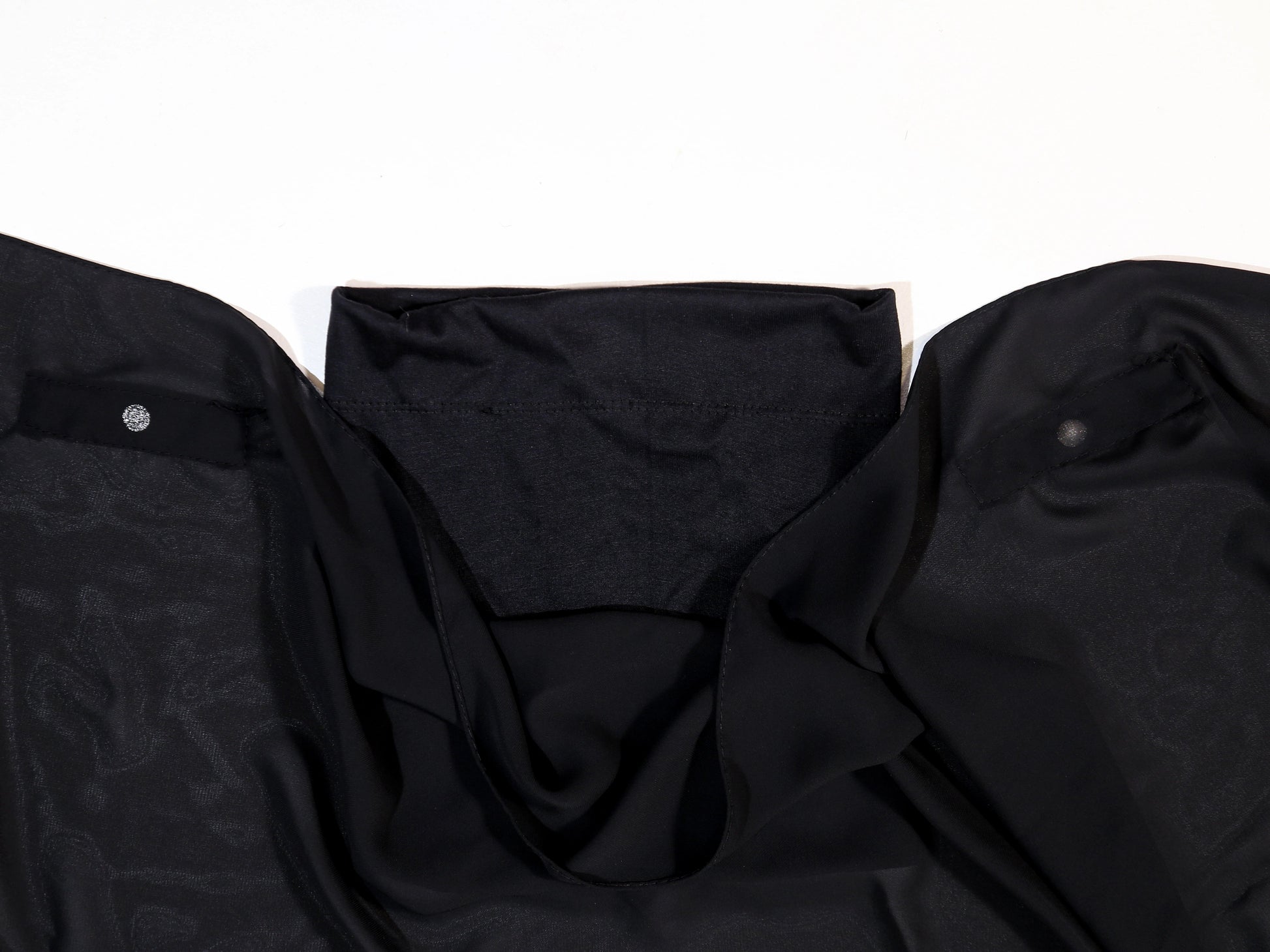 Black shirt with patterned collar on a white background