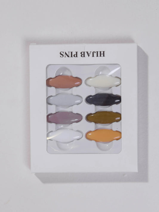 Set of colorful hair pins in a clear plastic window on a white background