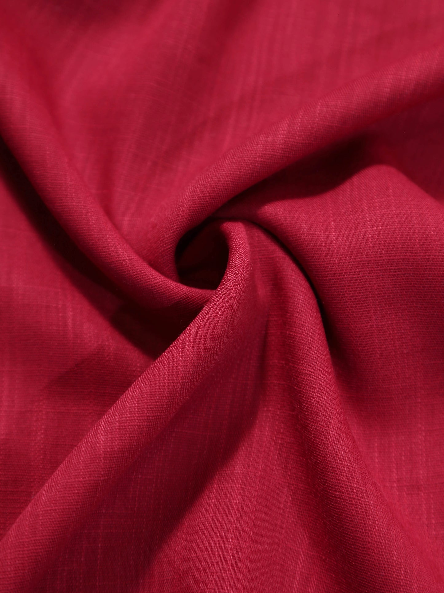 Close-up of red fabric with a focus on texture and color.