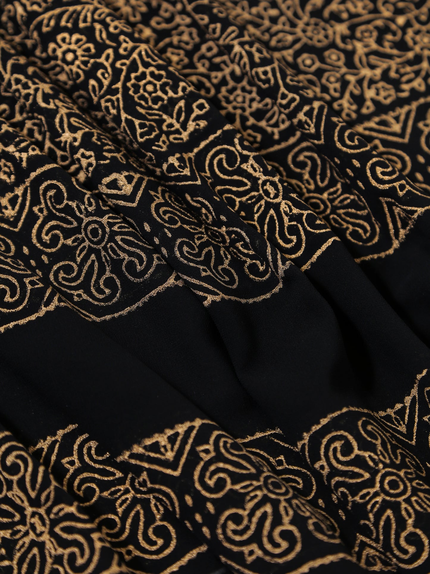 Black fabric with gold intricate patterns