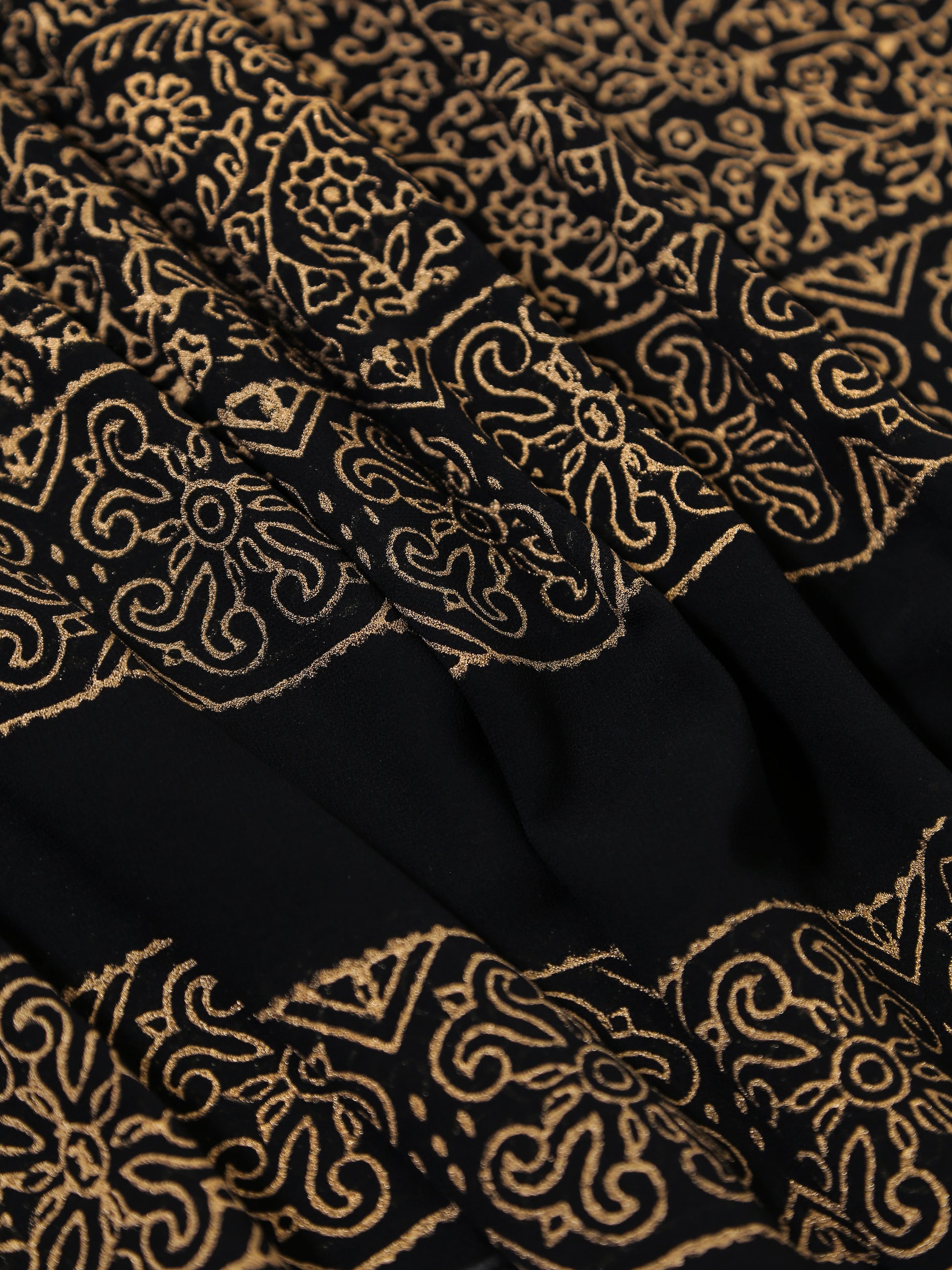 Black fabric with gold intricate patterns