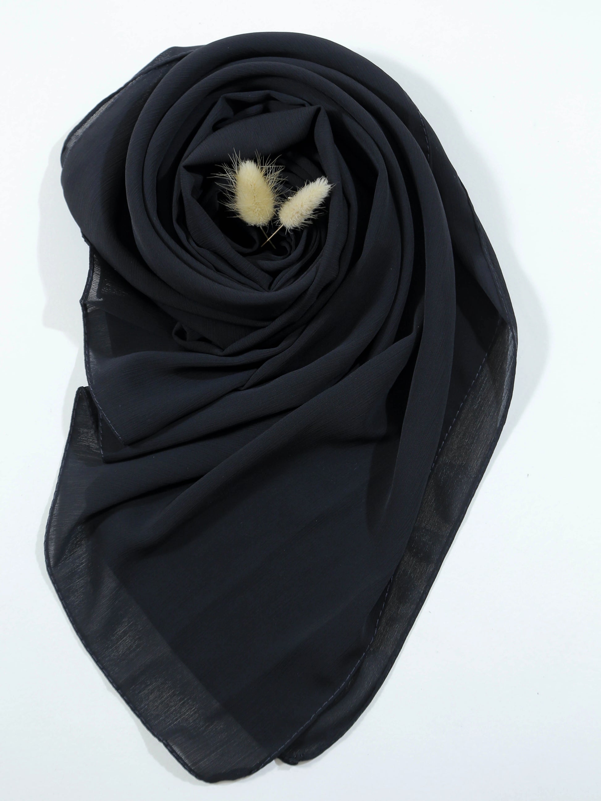 Black scarf with decorative elements on a white background