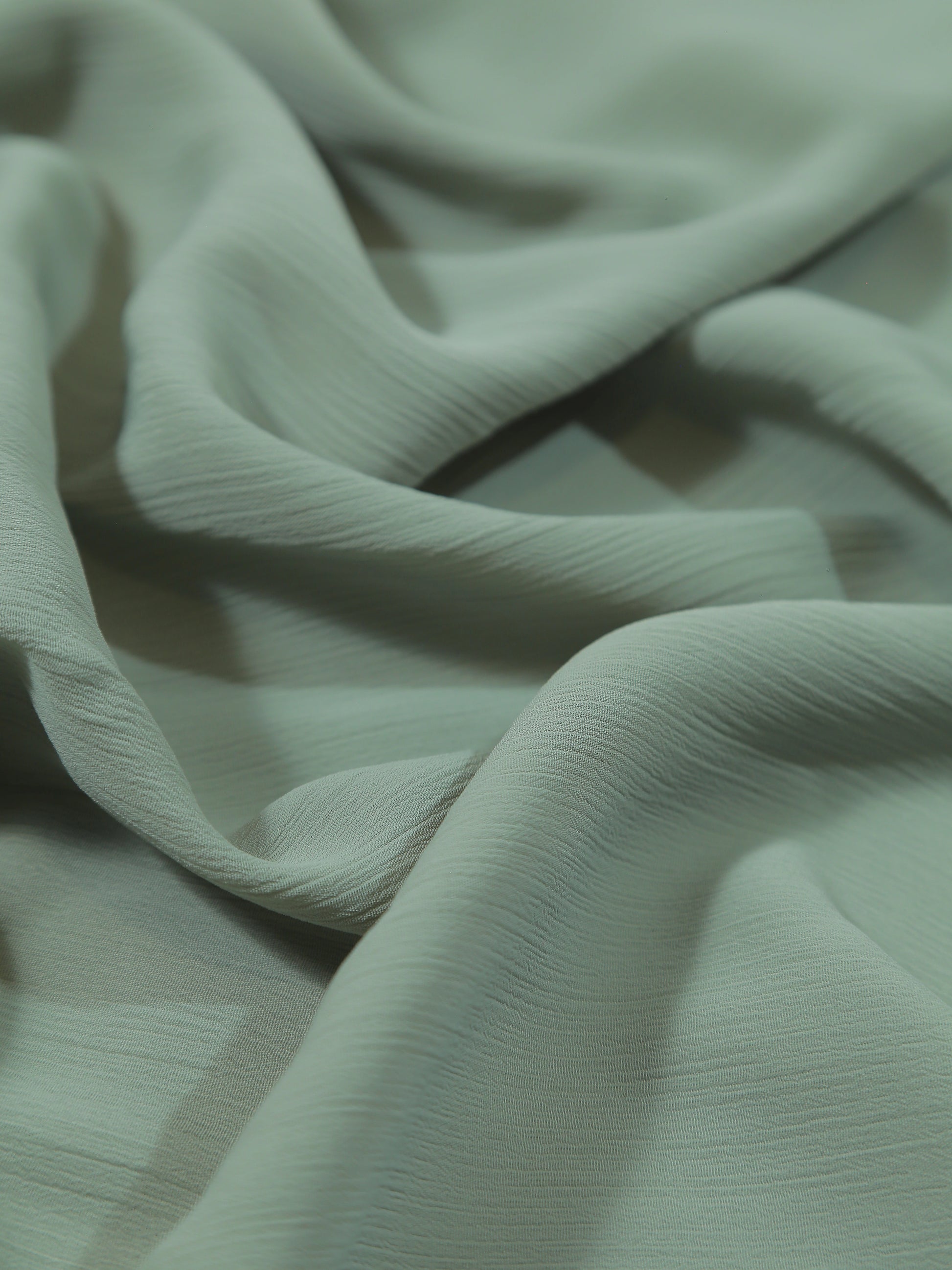 Close-up of light green fabric with a soft texture