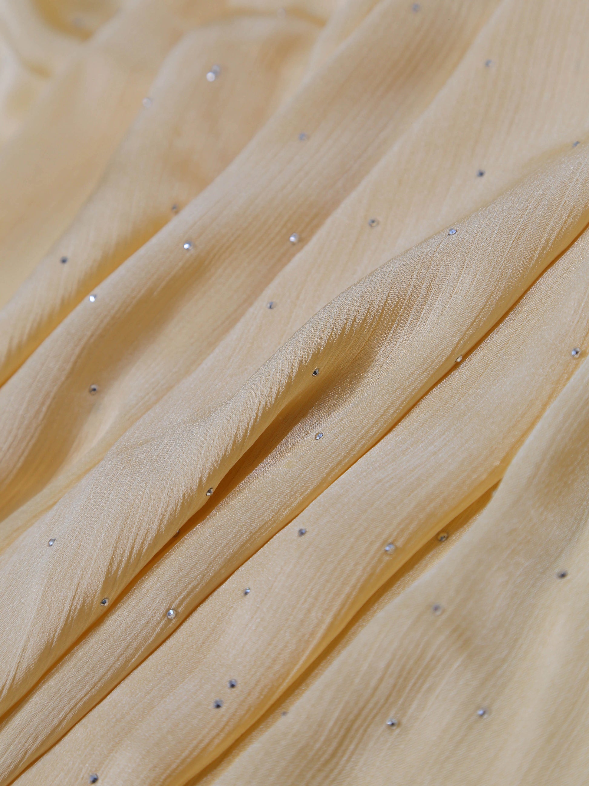 Close-up of soft cream fabric with small shiny embellishments from Premium Diamante Silk Hijab - Cream