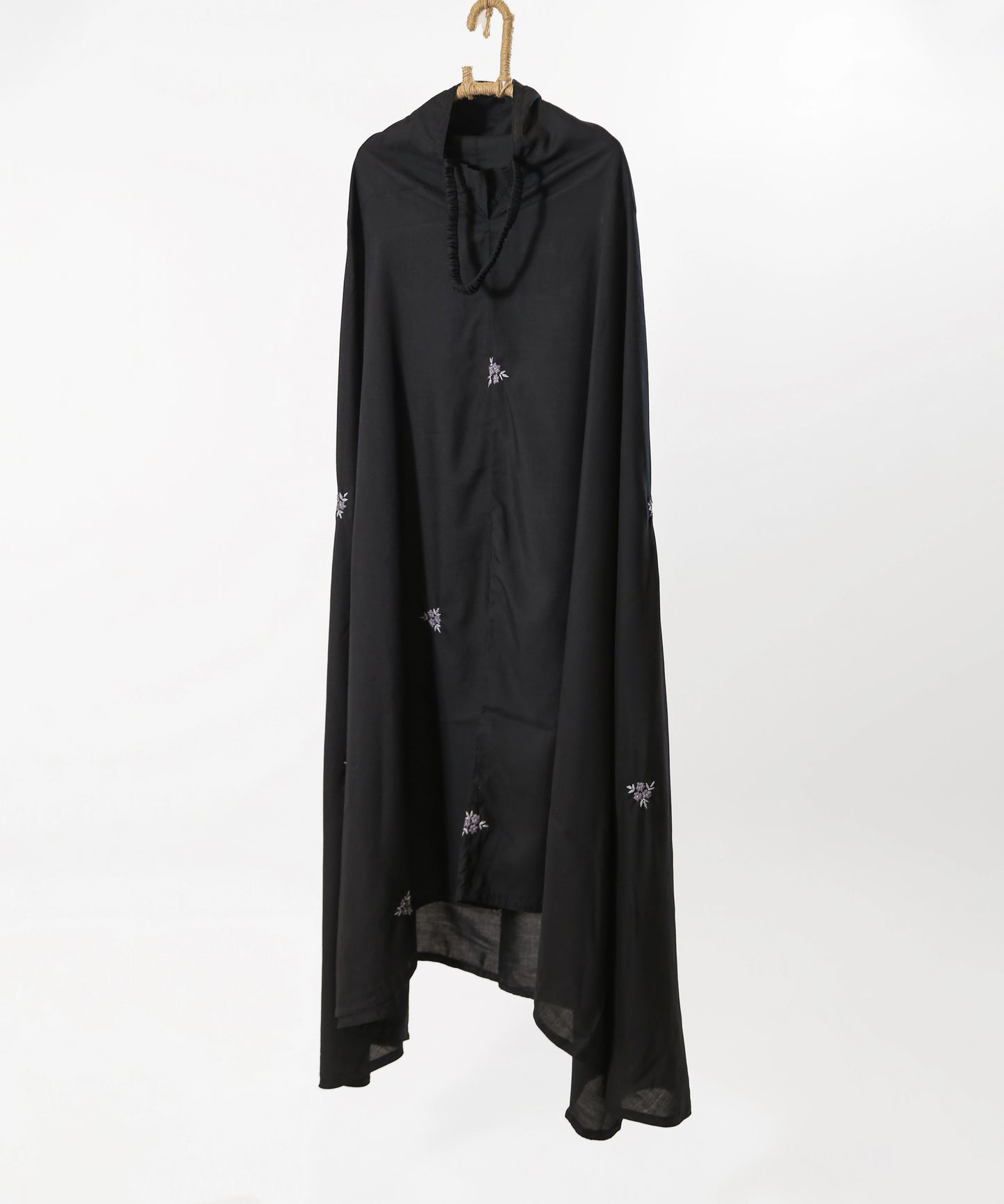 Black long garment with small white patterns on a white background