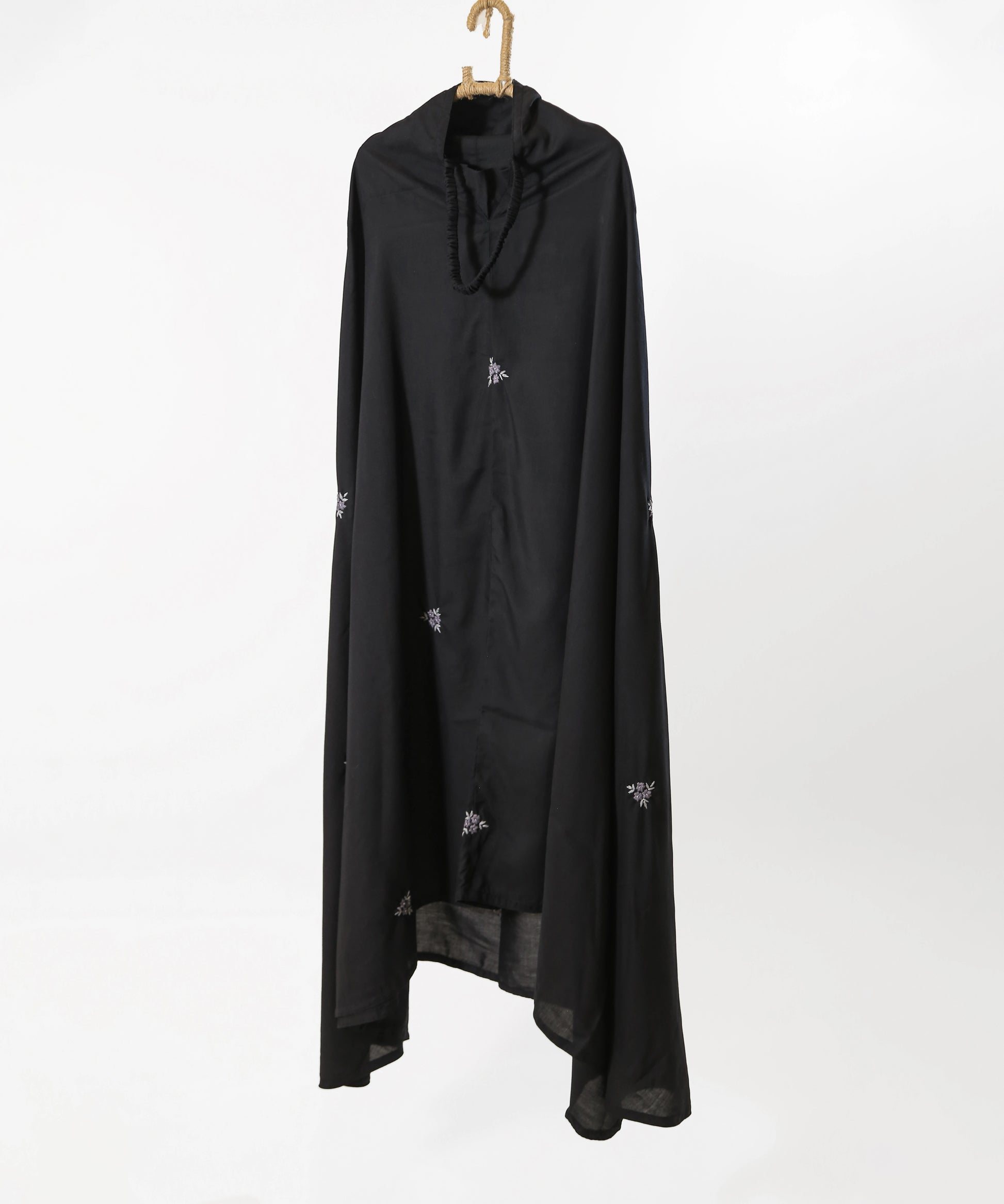 Black long garment with small white patterns on a white background