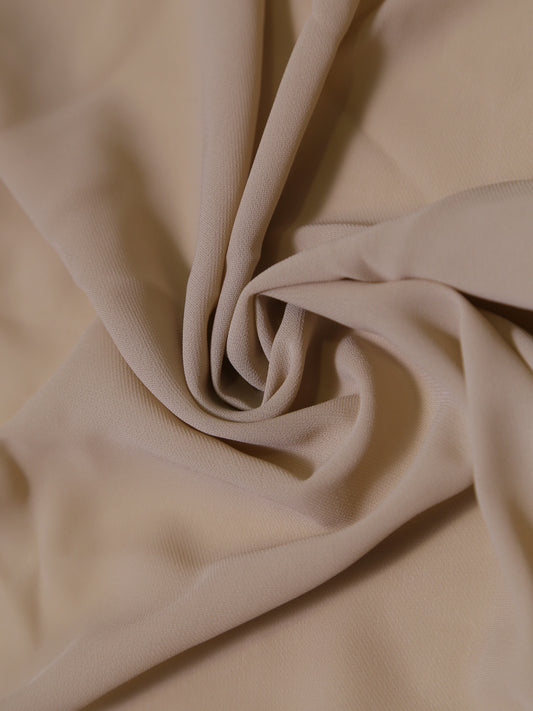 Close-up of beige fabric with folds
