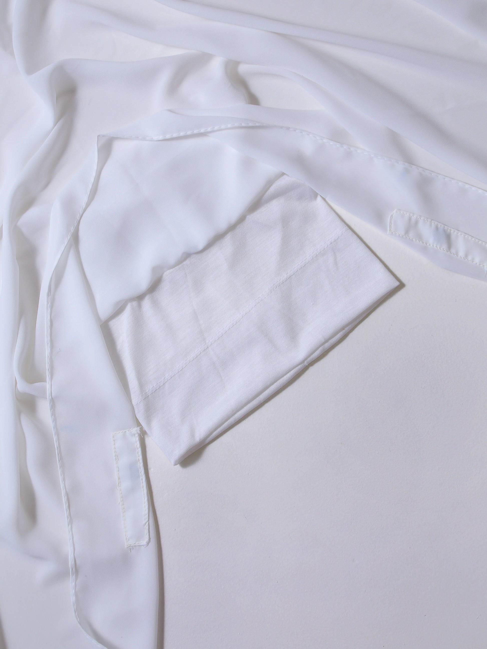 White t-shirt with a pocket on a light gray background
