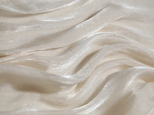 Close-up of smooth, white fabric with wavy texture