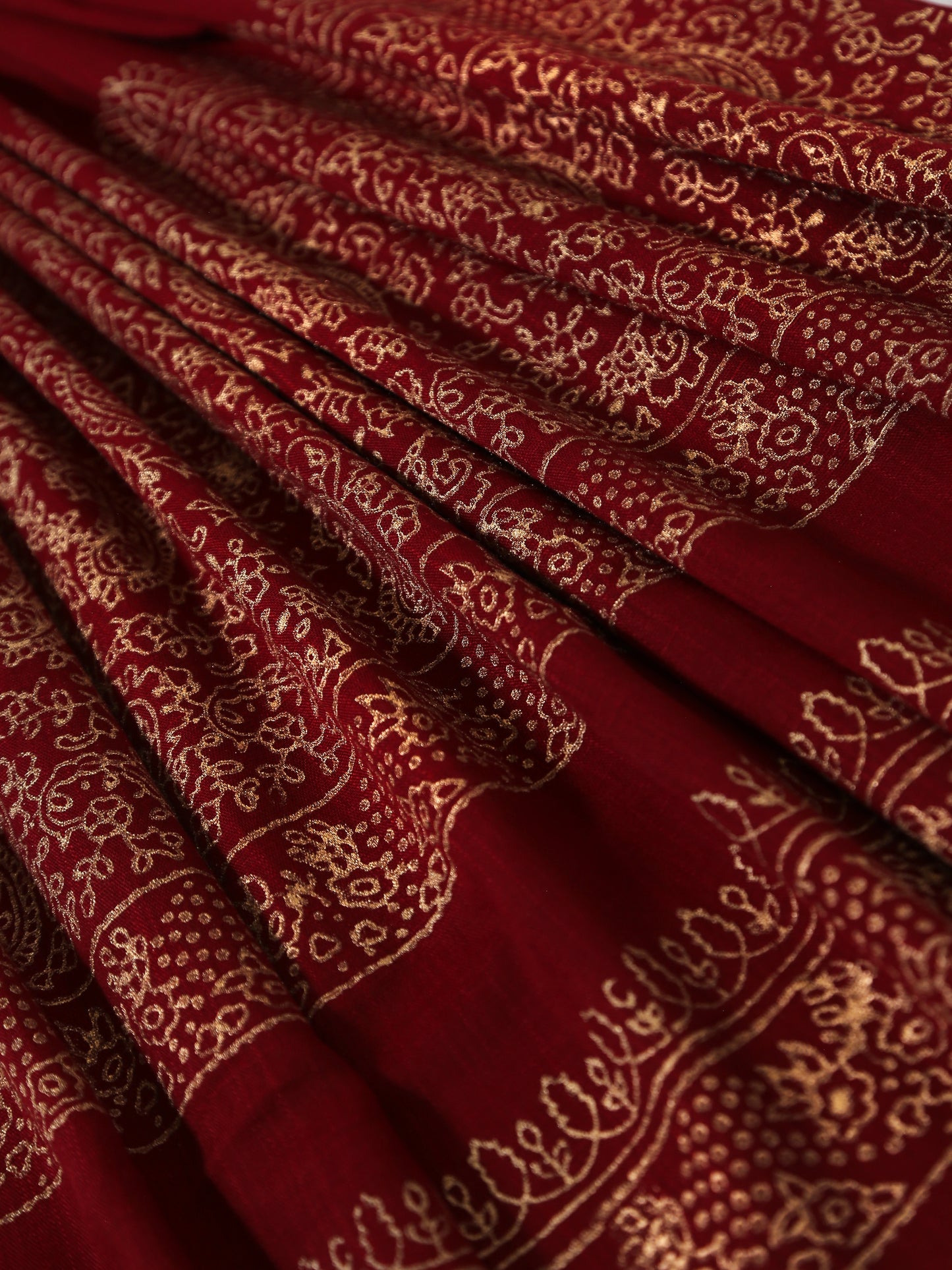 Close-up of red fabric with intricate gold patterns
