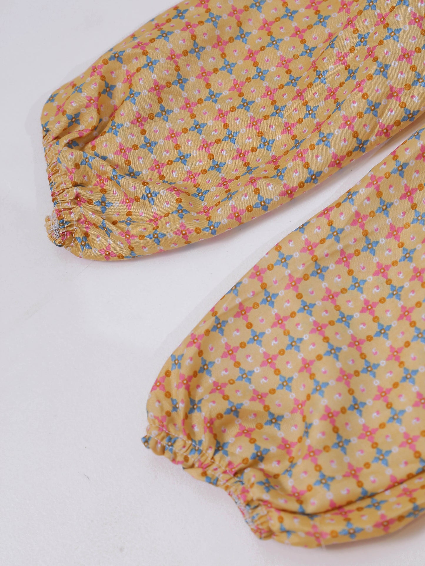 Two floral-patterned ironing boards on a white background