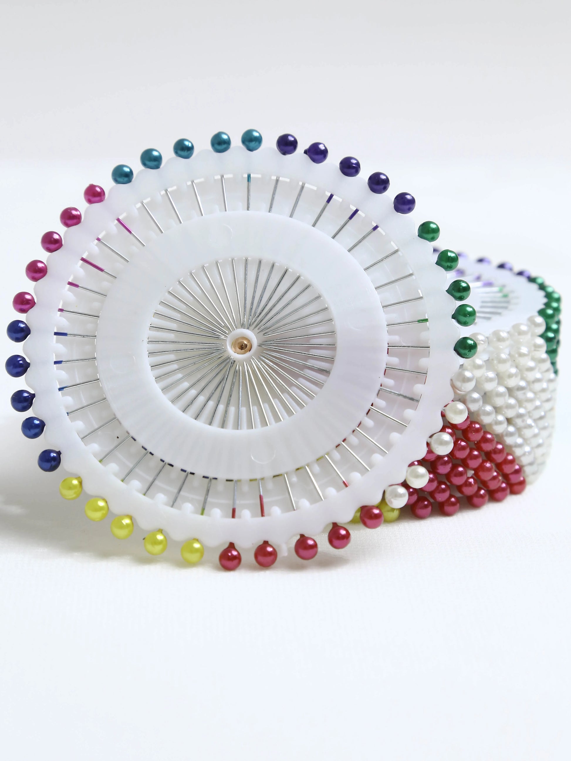 Circular object with colorful beads on a white background