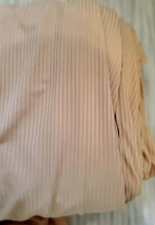 Close-up of beige fabric with a subtle pattern