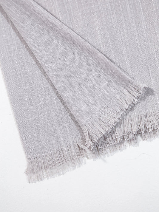 Gray textured fabric with fringes on a white background
