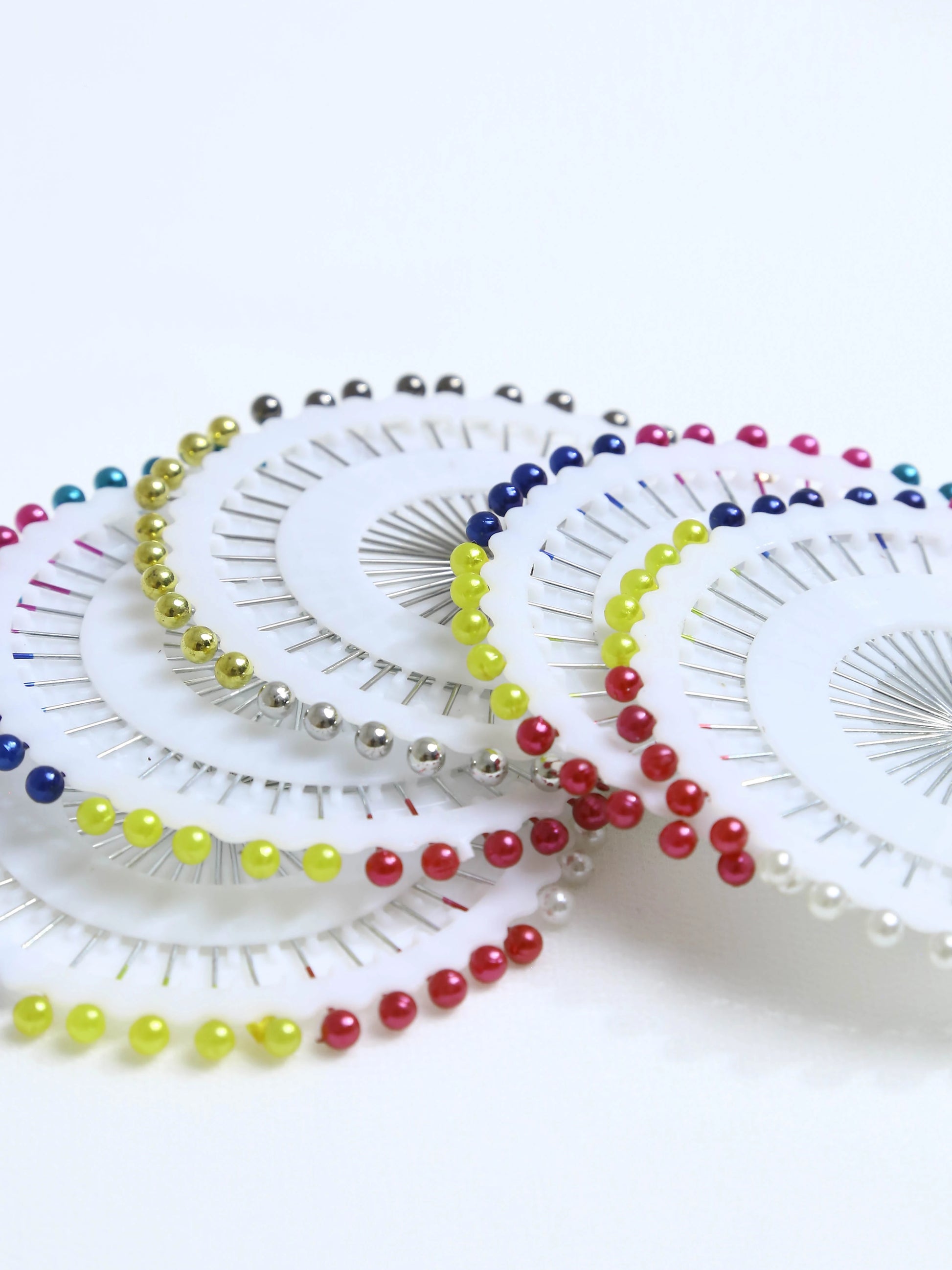 Colorful sewing pins on a white background